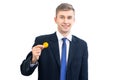 Happy young attractive businessman trader holding bitcoin cryptocurrency, isolated on white Royalty Free Stock Photo