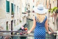 Happy young attractive woman fashion model of venice italy in blue polka dot outfit