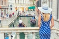 Happy young attractive woman fashion model of venice italy in blue polka dot outfit