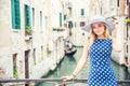 Happy young attractive woman fashion model of venice italy in blue polka dot outfit