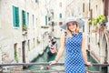 Happy young attractive woman fashion model of venice italy in blue polka dot outfit