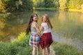 Happy young awesome women spending time near the lake