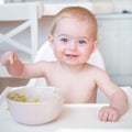 Happy Baby eating first solid food Royalty Free Stock Photo