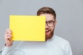 Happy young bearded businessman holding copyspace blank Royalty Free Stock Photo