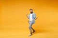 Happy young bearded man in casual blue shirt posing isolated on yellow orange background studio portrait. People sincere Royalty Free Stock Photo