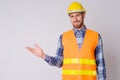 Happy young bearded man construction worker showing something Royalty Free Stock Photo