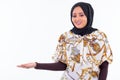 Happy young beautiful African Muslim woman showing something Royalty Free Stock Photo