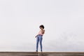 Happy young beautiful afro american woman smiling and talking on her mobile phone. cloudy background. Spring or summer season. Royalty Free Stock Photo