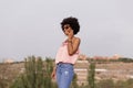 Happy young beautiful afro american woman smiling and talking on her mobile phone. urban background. Spring or summer season. Royalty Free Stock Photo