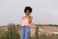 Happy young beautiful afro american woman smiling and talking on her mobile phone. urban background. Spring or summer season. Royalty Free Stock Photo