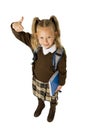 Happy young beautiful blond schoolgirl with pigtails and school uniform carrying backpack