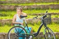 Happy Young Beautiful Blond Woman with Lady's Bicycle Outdoor