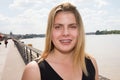 Happy young beautiful blonde braces girl tourist woman smiling on the footbridge