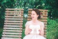 Happy Young beautiful bride with a cup of coffee waiting for her groom.Young beautiful bride drinking coffee at the outdoors cafe Royalty Free Stock Photo