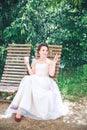 Happy Young beautiful bride with a cup of coffee waiting for her groom.Young beautiful bride drinking coffee at the outdoors cafe Royalty Free Stock Photo