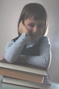 Happy young beautiful child girl with books. Vertical image