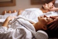 Happy young beautiful couple enjoying head massage at the spa Royalty Free Stock Photo