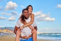 Happy young beautiful couple having fun on the beach. Royalty Free Stock Photo