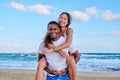 Happy young beautiful couple having fun on the beach. Royalty Free Stock Photo