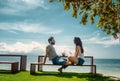 Happy young beautiful couple in love at tropical resort enjoying vacation drinking cocktails on the beach with sea view Royalty Free Stock Photo