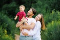 Happy young beautiful family with a young son is enjoying a wonderful day in the summer park Royalty Free Stock Photo