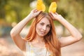 Happy young, beautiful red-haired girl in autumn park.