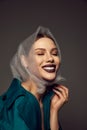 Happy young beautiful woman with artistic makeup laughing with closed eyes over grey background. Concept of beauty, high Royalty Free Stock Photo