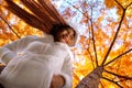 Happy young beautiful woman in autumn park on sunny day, Young woman in white coat during sunset in the park Royalty Free Stock Photo