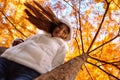 Happy young beautiful woman in autumn park on sunny day, Young woman in white coat during sunset in the park Royalty Free Stock Photo