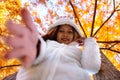 Happy young beautiful woman in autumn park on sunny day, Young woman in white coat during sunset in the park Royalty Free Stock Photo