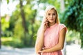 Happy young beautiful woman calling by phone in autumn on wall leaves green Royalty Free Stock Photo