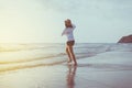 Happy young beautiful woman walking on sunset beach,Relaxing time,Positive thinking Royalty Free Stock Photo