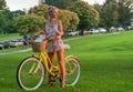 Happy young bicyclist riding in park.