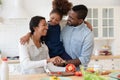 Happy young biracial family cooking with small daughter Royalty Free Stock Photo