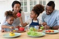 Happy young biracial family with kids cooking together Royalty Free Stock Photo