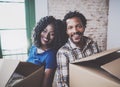 Happy young black african couple moving boxes into new home together and making a successful life.Cheerful family Royalty Free Stock Photo