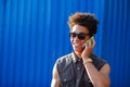 Happy young black african man with cell phone having conversation on mobile Royalty Free Stock Photo