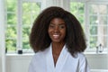 Happy young black African woman model wearing bathrobe in bathroom. Portrait Royalty Free Stock Photo