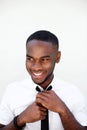 Happy young black businessman adjusting his necktie Royalty Free Stock Photo