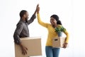 Happy Young Black Couple Giving High Five, Celebrating Moving To New House Royalty Free Stock Photo