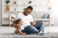 Happy Young Black Dad Using Laptop And Babysitting His Child At Home Royalty Free Stock Photo