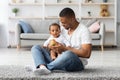 Happy Young Black Father Playing With Cute Infant Baby Son At Home Royalty Free Stock Photo