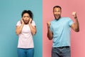 Happy young black man shouting loud, celebrating victory, scared woman closing her ears with fingers, shocked with noise Royalty Free Stock Photo