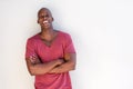 Happy young black man smiling against white wall Royalty Free Stock Photo