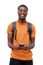 Happy young black man smiling with cellphone and bag against isolated white background Royalty Free Stock Photo