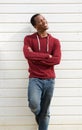 Happy young black man standing against white background Royalty Free Stock Photo