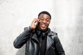 Happy young black man talking on mobile phone Royalty Free Stock Photo