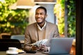 Happy young black manager holding money looking away Royalty Free Stock Photo