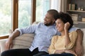 Happy young Black married couple relaxing on couch at home Royalty Free Stock Photo