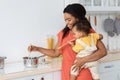 Happy Young Black Mother Cooking In Kitchen With Little Baby On Hands Royalty Free Stock Photo